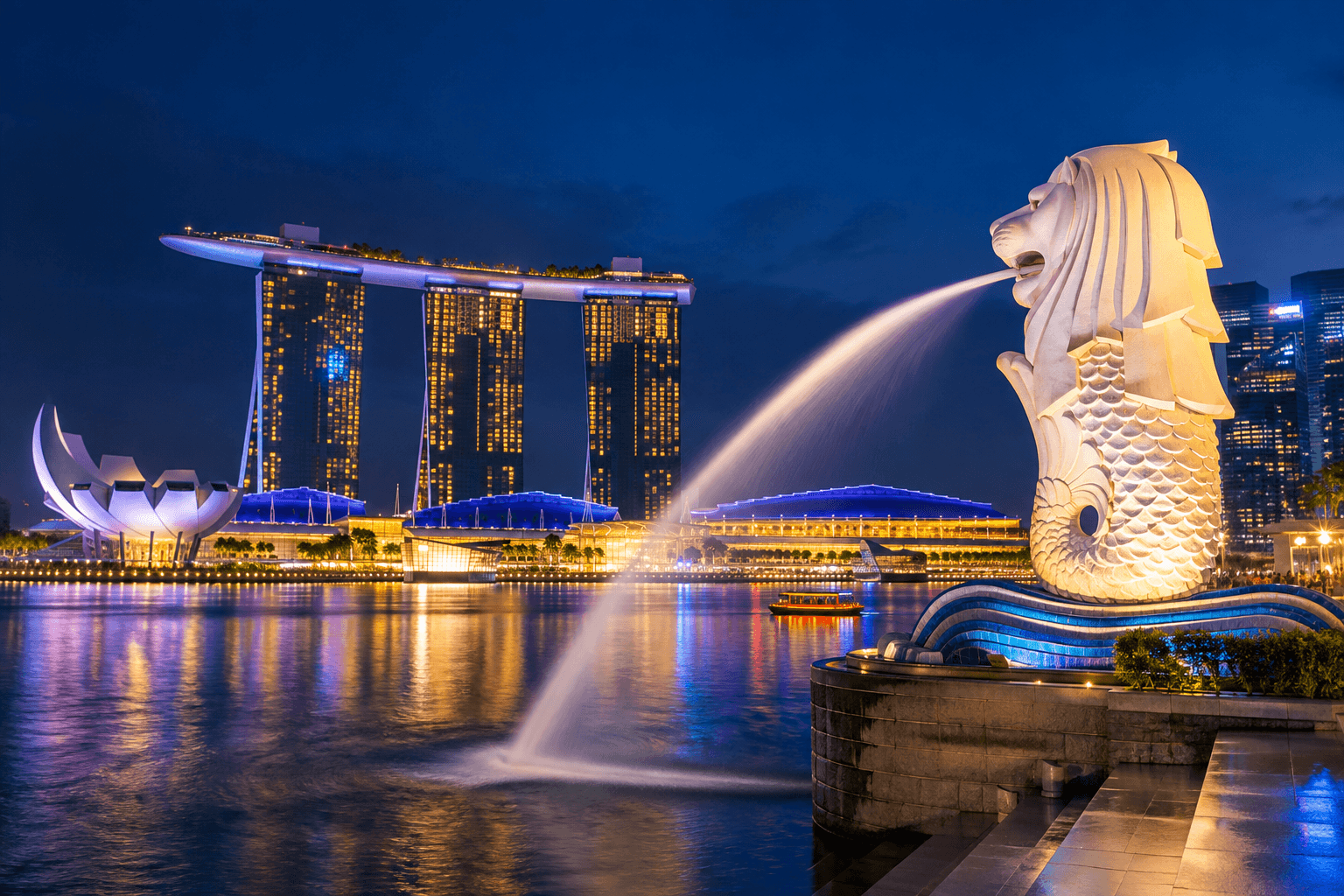 Marina Bay Sands and Singapore skyline illuminated beside the waterfront